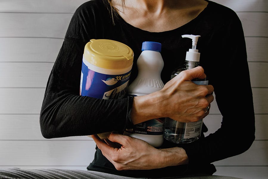 wiping-out-sars-covid-dissenfection Photo of person holding disinfectants