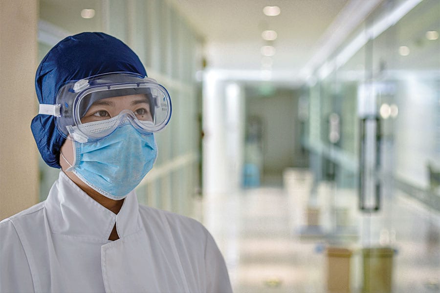wiping-out-sars-covid-masked-person Photo of hospital worker wearing a mask