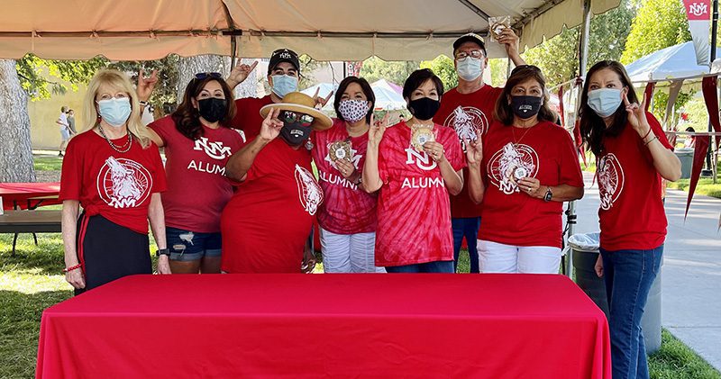 group photo of albuquerque alumni chapter members wearing masks and cherry lobo attire
