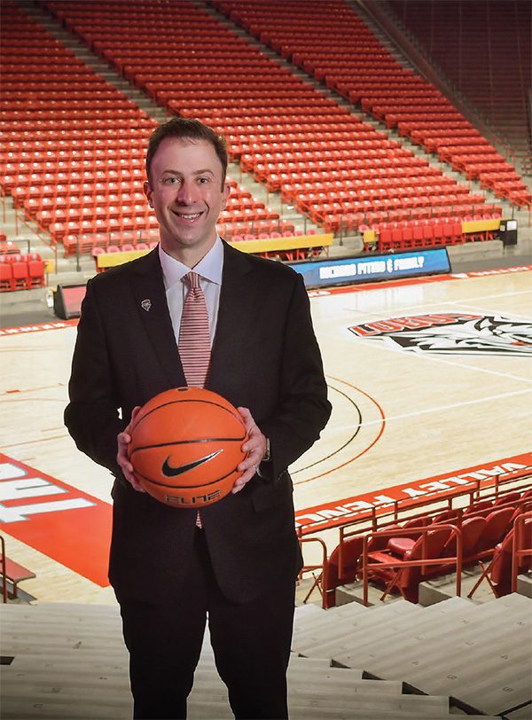 pitino-2 Richard Pitino holding a basketball with the Pit arena court behind him