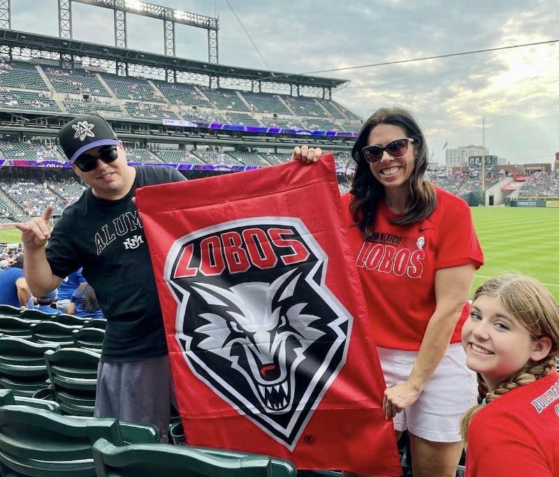 family in rockies and lobo gear and rockies stadium in Denver