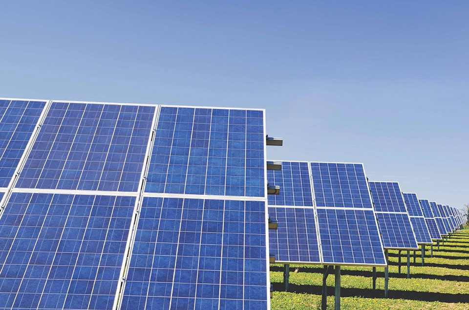 Photo of an array of solar panels facing the sun
