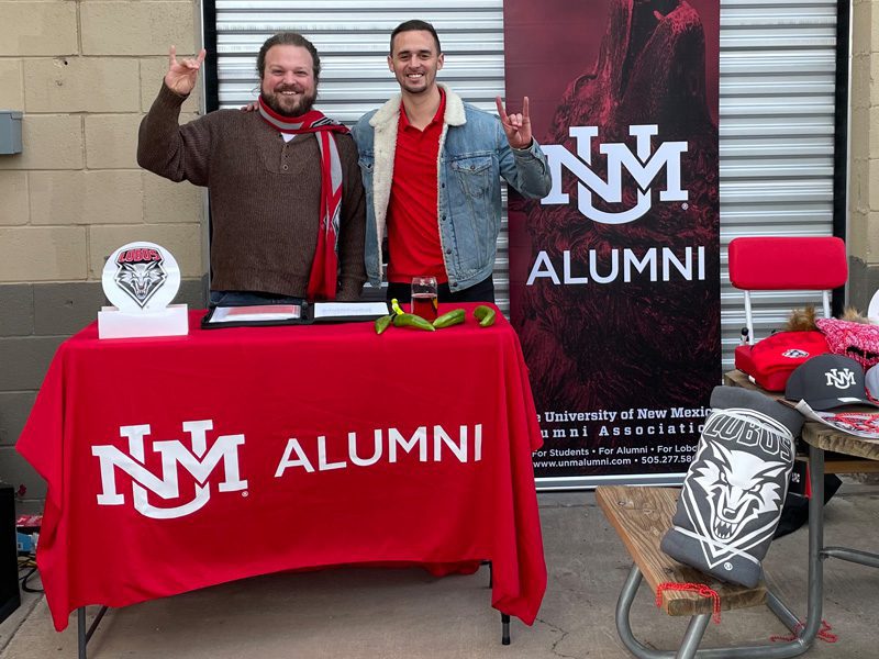 Aaron Currence (‘15 MA), Young Alumni President, and Adam Biederwolf (’20 BBA) at the inaugural Young Alumni Green Chile Roast at Bombs Away Beer Company