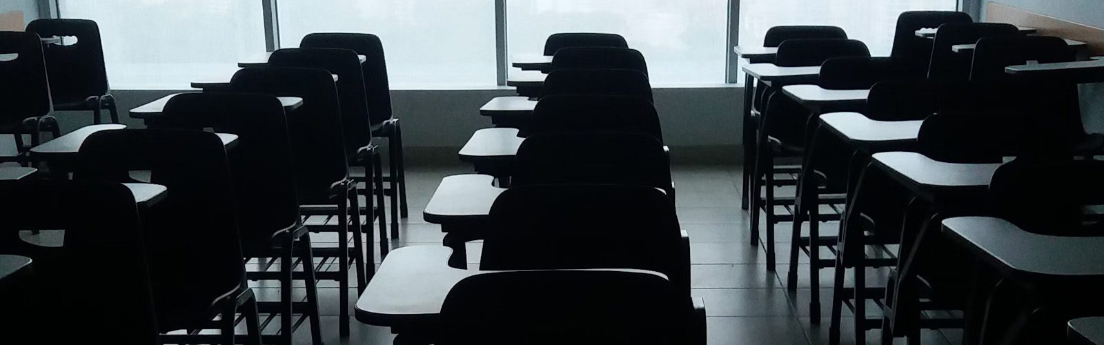 an empty classroom with rows of desks