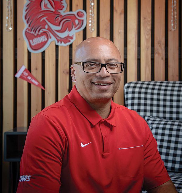 Alumni President Mike Silva in a cherry UNM polo