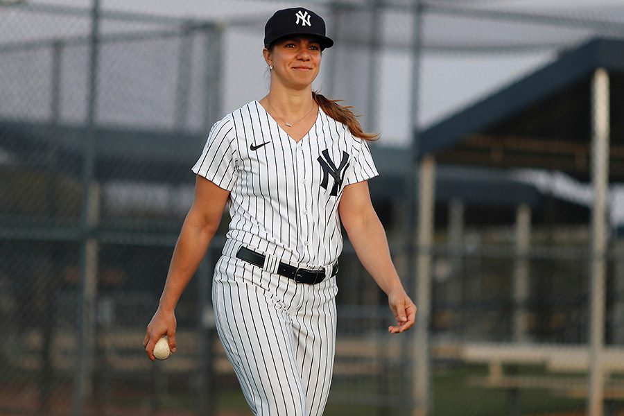 Rachel Balkovec walking on a baseball field in Yankee pinstripes