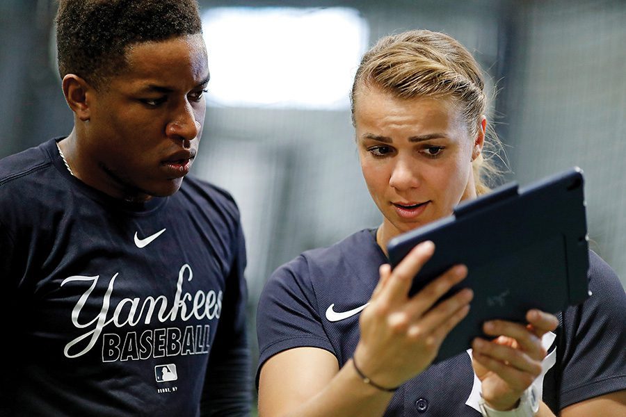 rachel-balkovec-2 Rachel coaching with an ipad while a yankee player looks on