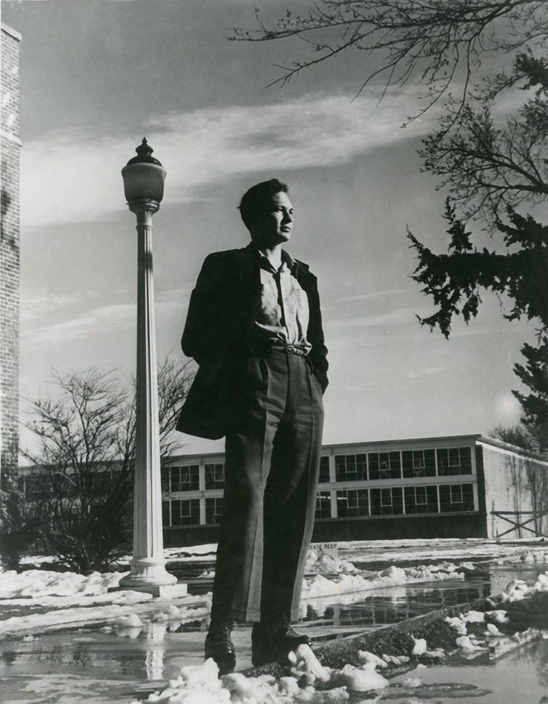 black and white photo of a youthful Tony Hillerman on campus