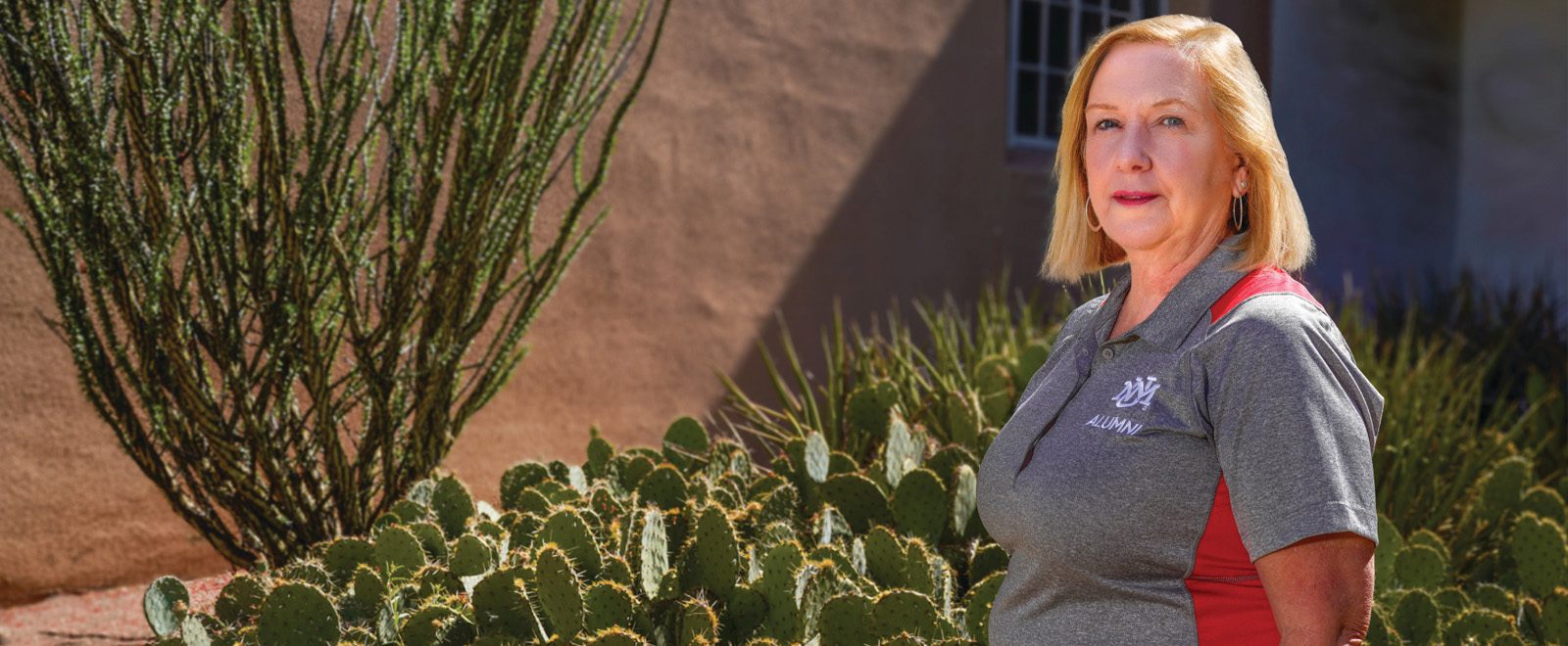 Amy Milller outside with cactii in background