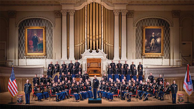 group portrait of large army band in patriotic setting