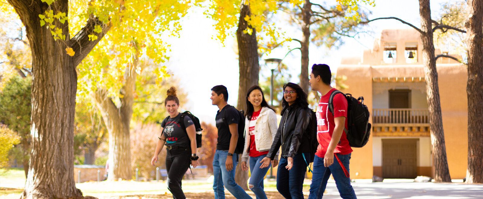 fall-campus UNM students walking on campus under fall leaves