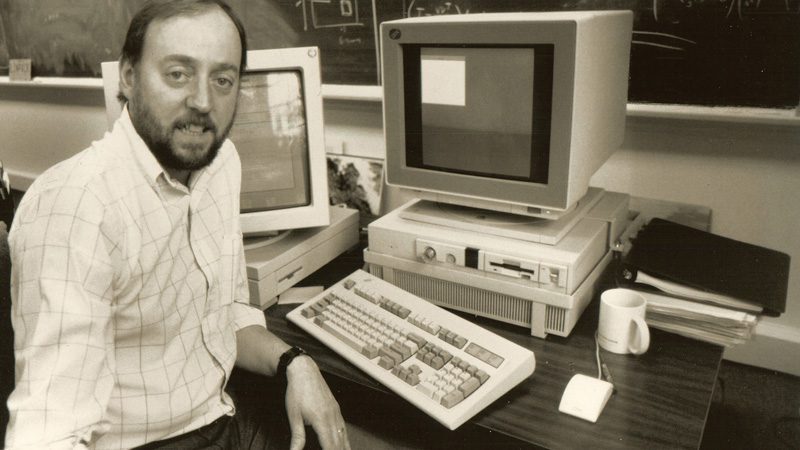 black and white photo of a youthful jack dongarra seated at a computer